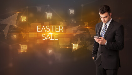Businessman with shopping cart icons and EASTER SALE inscription, online shopping concept