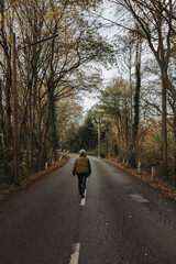 Girl walks lonely street surrounded by beautiful fall colors