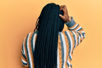 Young black woman with braids wearing casual winter sweater backwards thinking about doubt with...