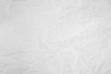 white and gray crumpled paper texture background. crush paper so that it becomes creased and...