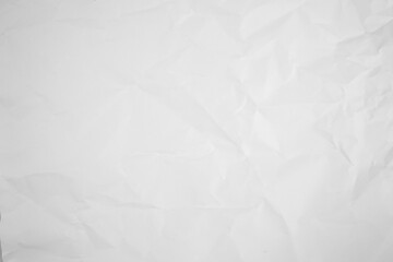 white and gray crumpled paper texture background. crush paper so that it becomes creased and...