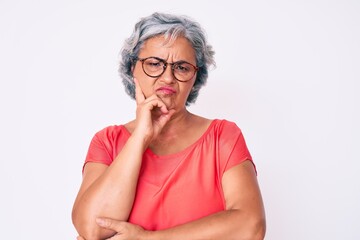 Senior hispanic grey- haired woman wearing casual clothes and glasses thinking looking tired and bored with depression problems with crossed arms.