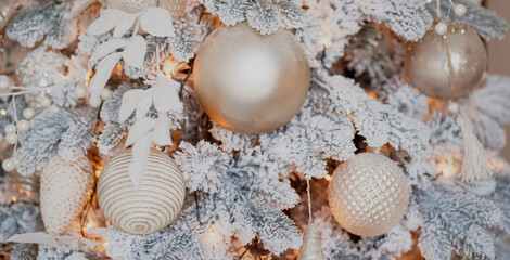 Beautiful decorations for the holiday of merry Christmas and new year. space for copying. holiday decorations Golden balls garland of Golden color, white Christmas tree with snow.