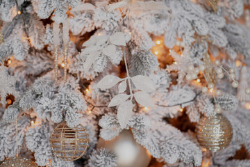 holiday decorations garland of Golden color, white Christmas tree with snow. Beautiful decorations for the holiday of merry Christmas and new year. copy space