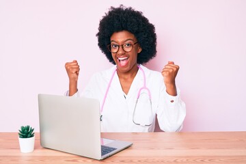 Young african american woman wearing doctor stethoscope working using computer laptop screaming proud, celebrating victory and success very excited with raised arms