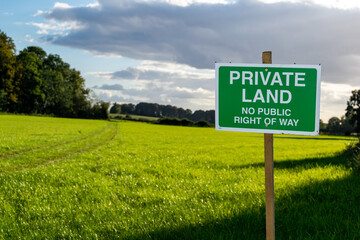 Private land no public right of way saying sign, beautiful, inviting lush open grassland behind,...