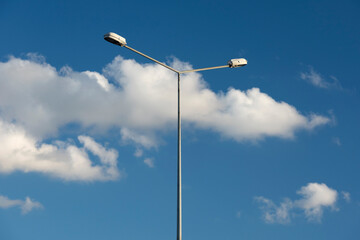 Highway lamp on the blue sky.