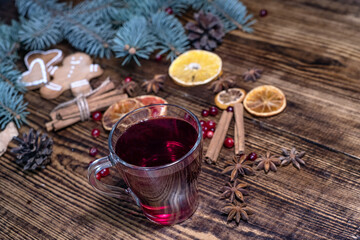 Christmas mulled red wine with and ingredients on a wooden brown table. Traditional hot drink at...