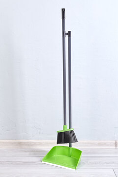 Fastened dustpan and brush for cleaning floor from dust and trash.