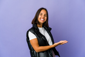 Young mixed race woman holding a copy space on a palm.