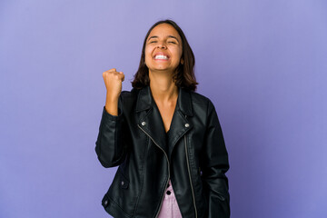 Young mixed race woman celebrating a victory, passion and enthusiasm, happy expression.