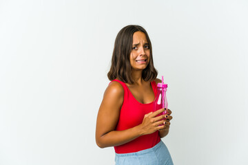 Young latin woman holding a milkshake isolated on white background