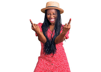 Young african american woman wearing summer hat showing middle finger doing fuck you bad expression, provocation and rude attitude. screaming excited