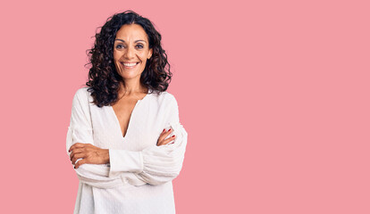 Middle age beautiful woman wearing casual sweater happy face smiling with crossed arms looking at the camera. positive person.