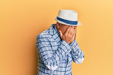 Mature middle east man with mustache wearing vintage and elegant fashion style with sad expression covering face with hands while crying. depression concept.