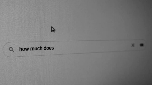 Close-up of a monitor screen with a browser search bar - how much does the Covid-19 vaccine cost. Searching the internet for information on pandemic covid-19.