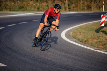 Fototapeta na wymiar Sporty man in helmet and glasses riding bike