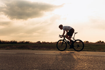 Fototapeta na wymiar Cyclist in helmet enjoying favorite sport activity outdoors