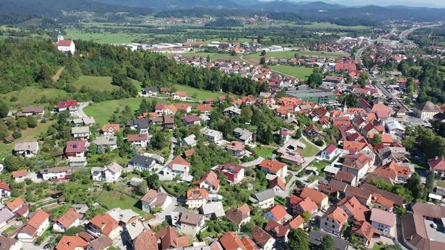Picturesque autumn landscape of Ljubljana Marshes overlooking brownish roofs of houses of small Slovenian town of Vrhnika