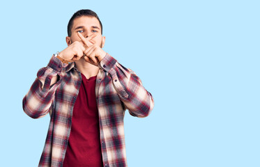 Young handsome man wearing casual shirt rejection expression crossing fingers doing negative sign