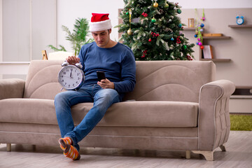 Young man celebrating Christmas alone at home