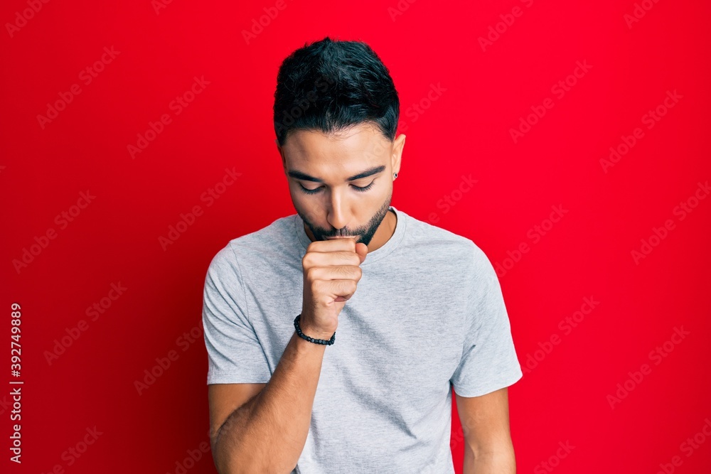 Canvas Prints Young man with beard wearing casual white tshirt feeling unwell and coughing as symptom for cold or bronchitis. health care concept.