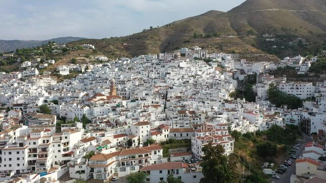 Aerial view of central areas of Competa overlooking parish Church of Assumption on sunny fall day, Andalusia, Spain. High quality 4k footage