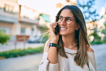 Young caucasian woman smiling happy talking on the smartphone at the city.