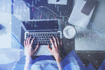 Double exposure of woman hands working on computer and forex chart hologram drawing. Top View. Financial analysis concept.