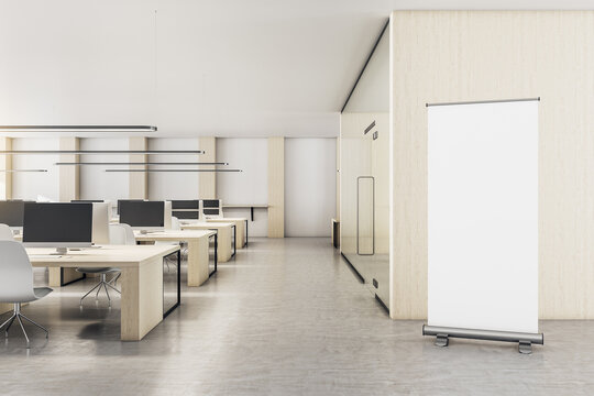 Contemporary office interior with vertical blank poster
