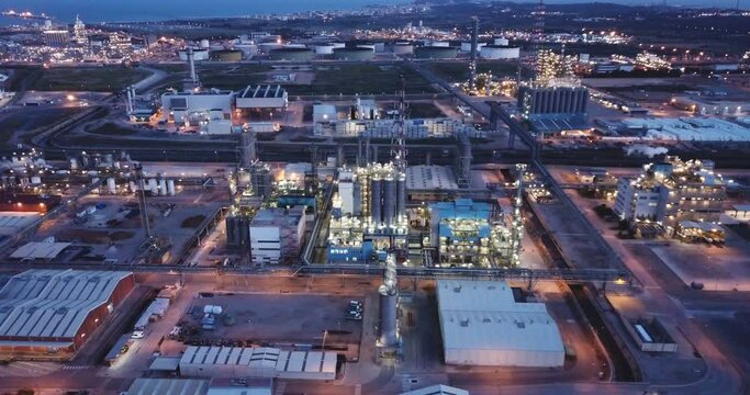 Night aerial panoramic view of large chemical plant located next to Salou city, Spain