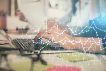 Multi exposure of woman hands typing on computer and financial graph hologram drawing. Stock market...