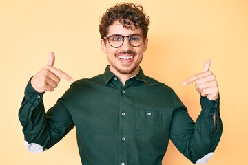 Young caucasian man with curly hair wearing casual clothes and glasses looking confident with smile...