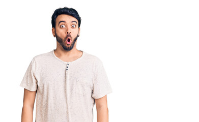 Young hispanic man wearing casual clothes afraid and shocked with surprise expression, fear and excited face.