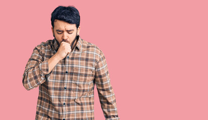 Young hispanic man wearing casual clothes feeling unwell and coughing as symptom for cold or bronchitis. health care concept.