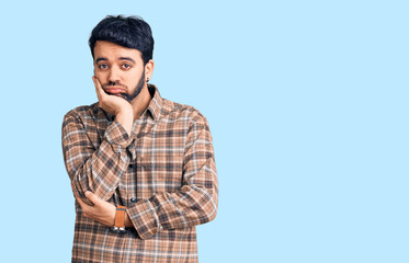 Young hispanic man wearing casual clothes thinking looking tired and bored with depression problems with crossed arms.