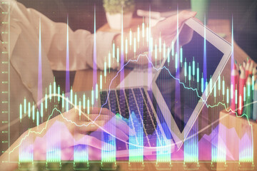 Double exposure of woman hands typing on computer and forex chart hologram drawing. Stock market invest concept.