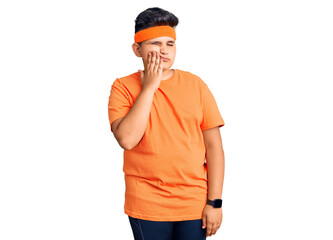 Little boy kid wearing sportswear touching mouth with hand with painful expression because of toothache or dental illness on teeth. dentist