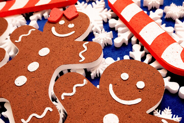 a lot of white foam snowflakes, candy lollipop, gingerbread people Christmas decor for home, office, shop.
