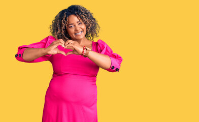 Young african american plus size woman wearing casual clothes smiling in love showing heart symbol and shape with hands. romantic concept.