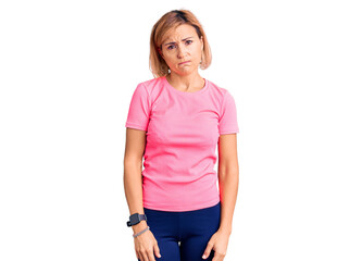 Obraz premium Young blonde woman wearing sportswear depressed and worry for distress, crying angry and afraid. sad expression.