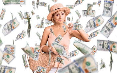 Young blonde woman wearing summer hat holding bag with angry face, negative sign showing dislike...