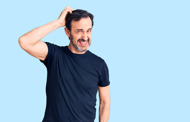 Middle age handsome man wearing casual t-shirt confuse and wonder about question. uncertain with...