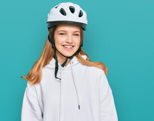 Beautiful young caucasian girl wearing bike helmet looking positive and happy standing and smiling with a confident smile showing teeth