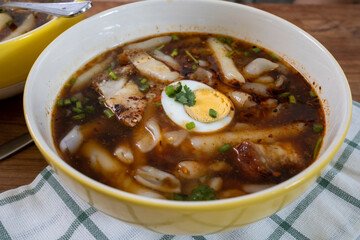 Kuay Jab Nam Kon, Thick Rolled Thai Noodles in Brown Pork Soup with Pork Belly 
