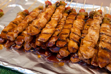 Grilled and marinated chicken skewers with chili and tomato, Thai street food
