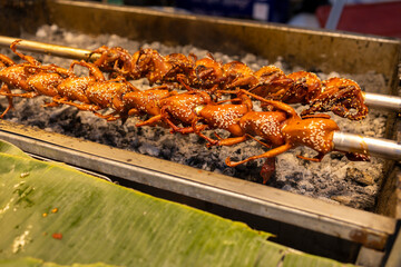 Quails on a rotisserie grill, Thai night market