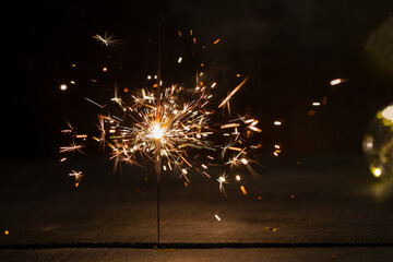 burning Sparkler on a dark wooden background