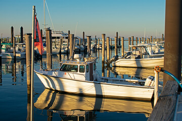 Motorboats lined up in berths at the Atlantic Highlands municipal harbor marina on a sunny day. -08