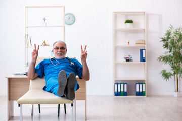 Old male doctor extremely tired after night shift